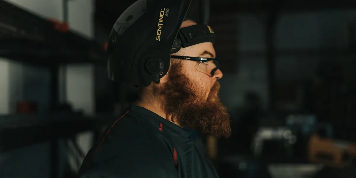 Innovations Manufacturing craftsman with welding helmet